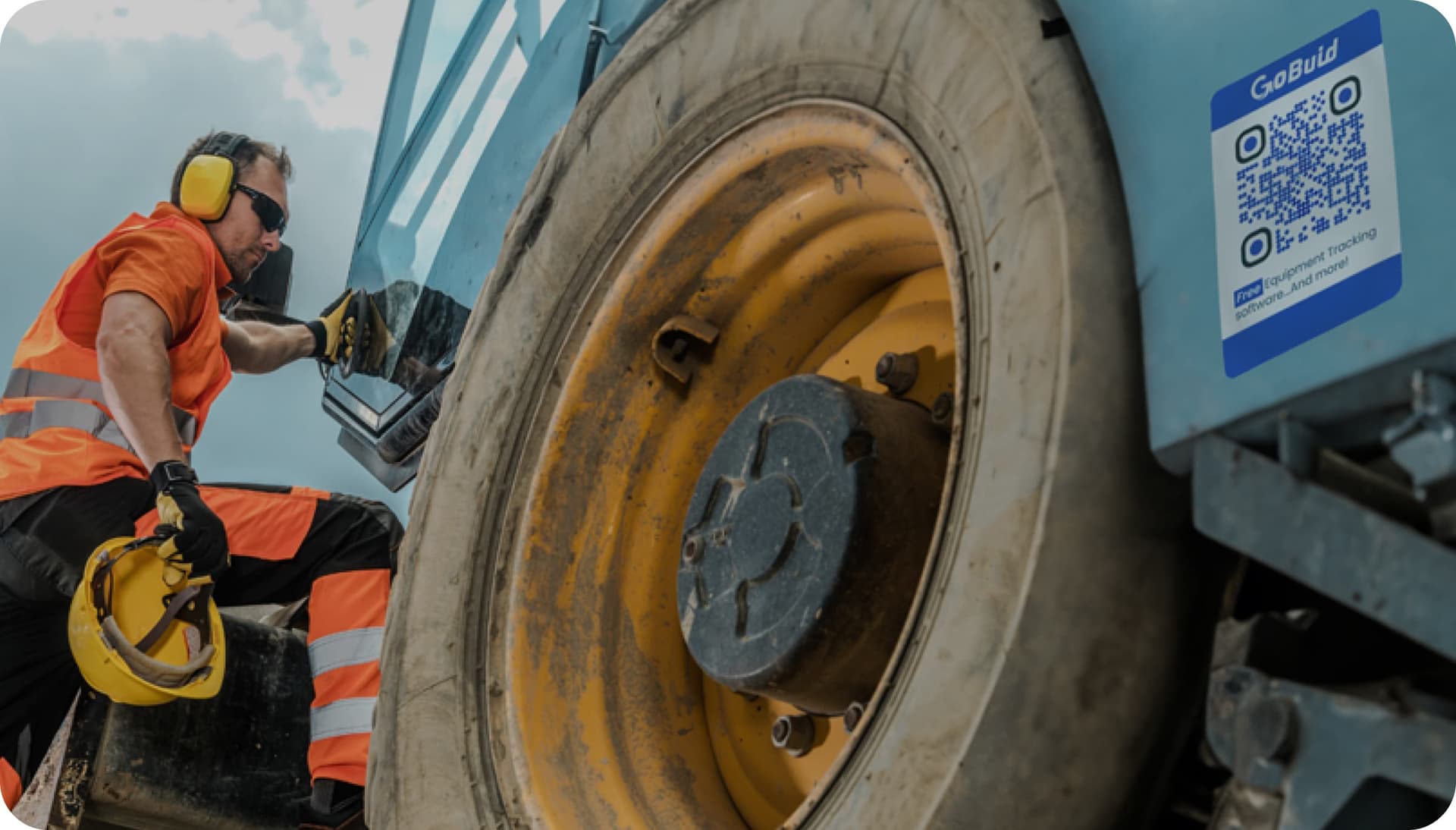 Worker interacting with machinery, scanning QR code for check-in and equipment location with GoBuid.